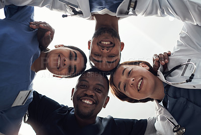 Buy stock photo Shot of a group of medical staff huddled together