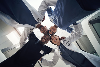 Buy stock photo Doctors, circle and below in portrait for team, diversity or solidarity in medical career at hospital. Medic group, men and women in collaboration, wellness or huddle for healthcare service at clinic