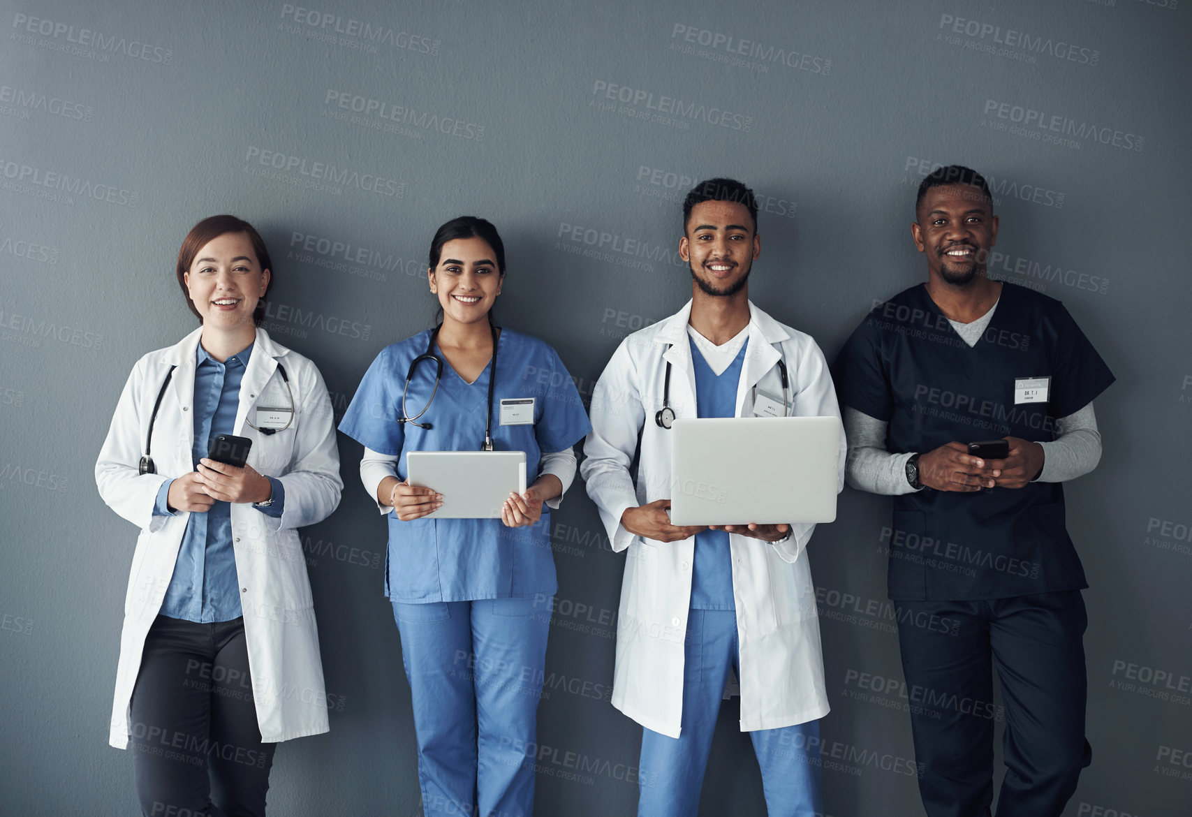 Buy stock photo Doctor, teamwork and technology on wall background for research, planning and multimedia workflow. Healthcare worker, group and nurse in portrait with laptop, tablet and phone for contact or about us