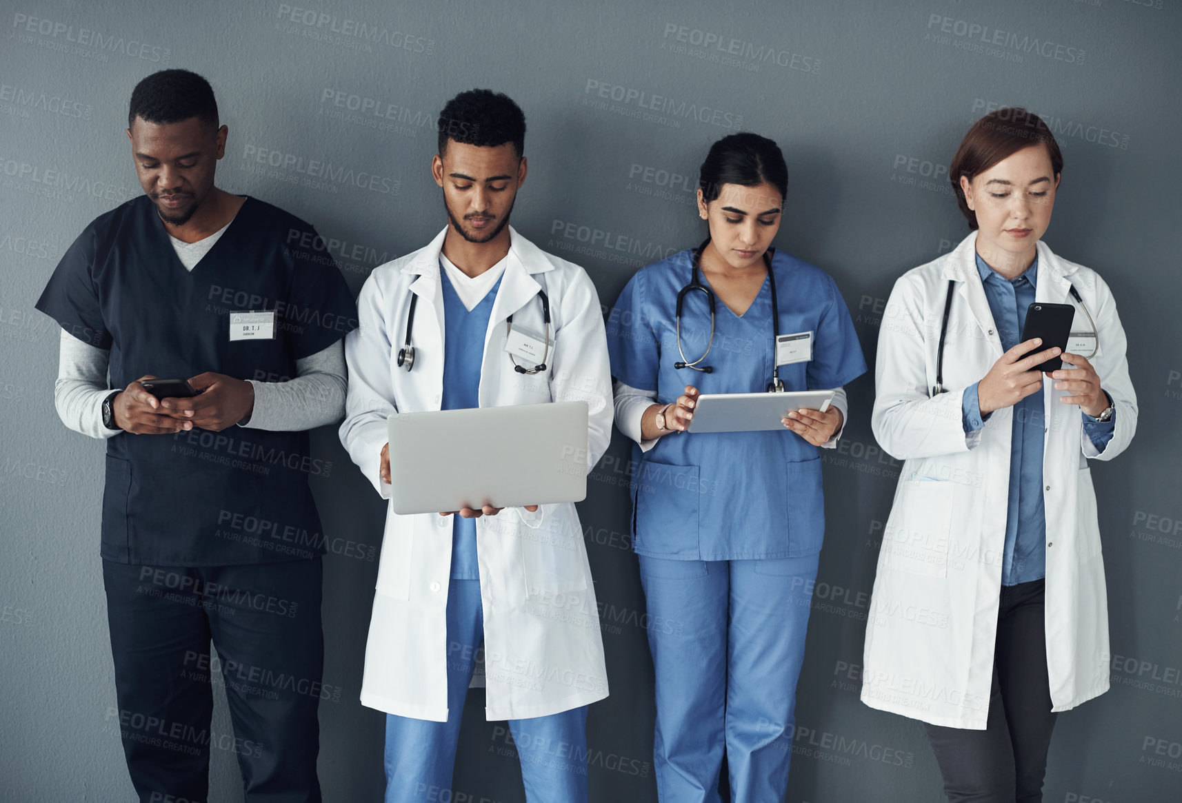 Buy stock photo Doctor, nurse and teamwork on technology and wall background for research, planning and medical workflow. Healthcare worker, group and staff with laptop, tablet and phone for contact and about us