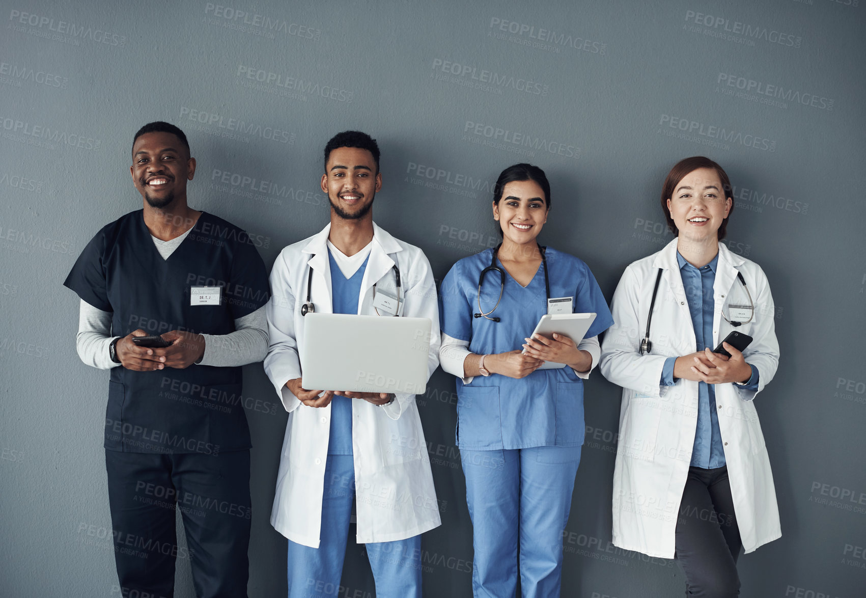 Buy stock photo Technology, doctors and portrait of team by wall for interview or public health conference and training session. People, medical staff and row for patient rounds or daily briefing, review and happy.