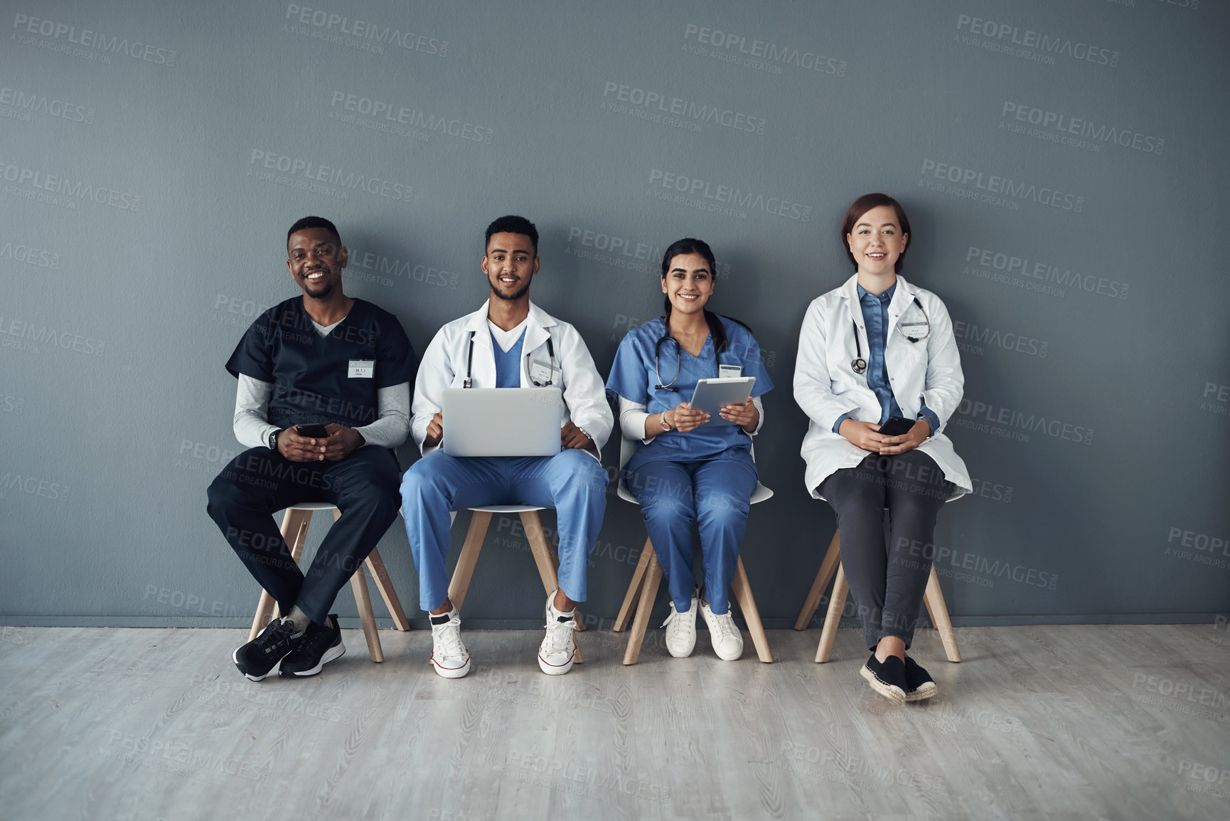 Buy stock photo Chairs, doctors and happy team by wall for interview or public health conference and training session or meeting. People, medical staff and line for patient rounds or daily briefing, review and proud