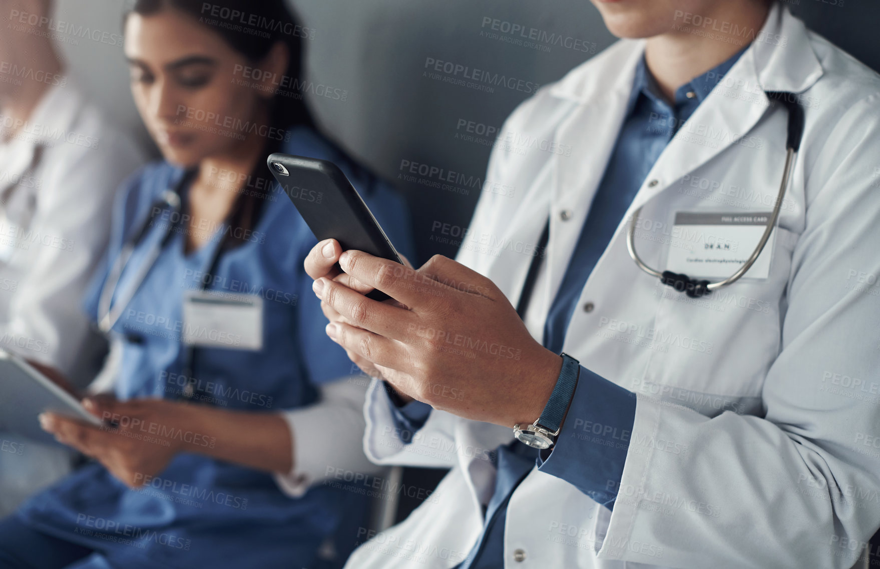 Buy stock photo Hospital, team and doctor with phone for telehealth, check test results and 5g network for healthcare article. Mobile, colleagues and medical expert by wall for wellness app and research diagnosis