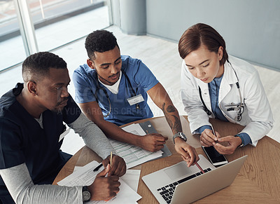 Buy stock photo Shot a group of doctors discussing work matters in the office at work