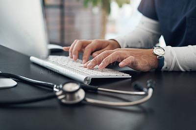 Buy stock photo Shot of an unrecognizable doctor using computer in an office