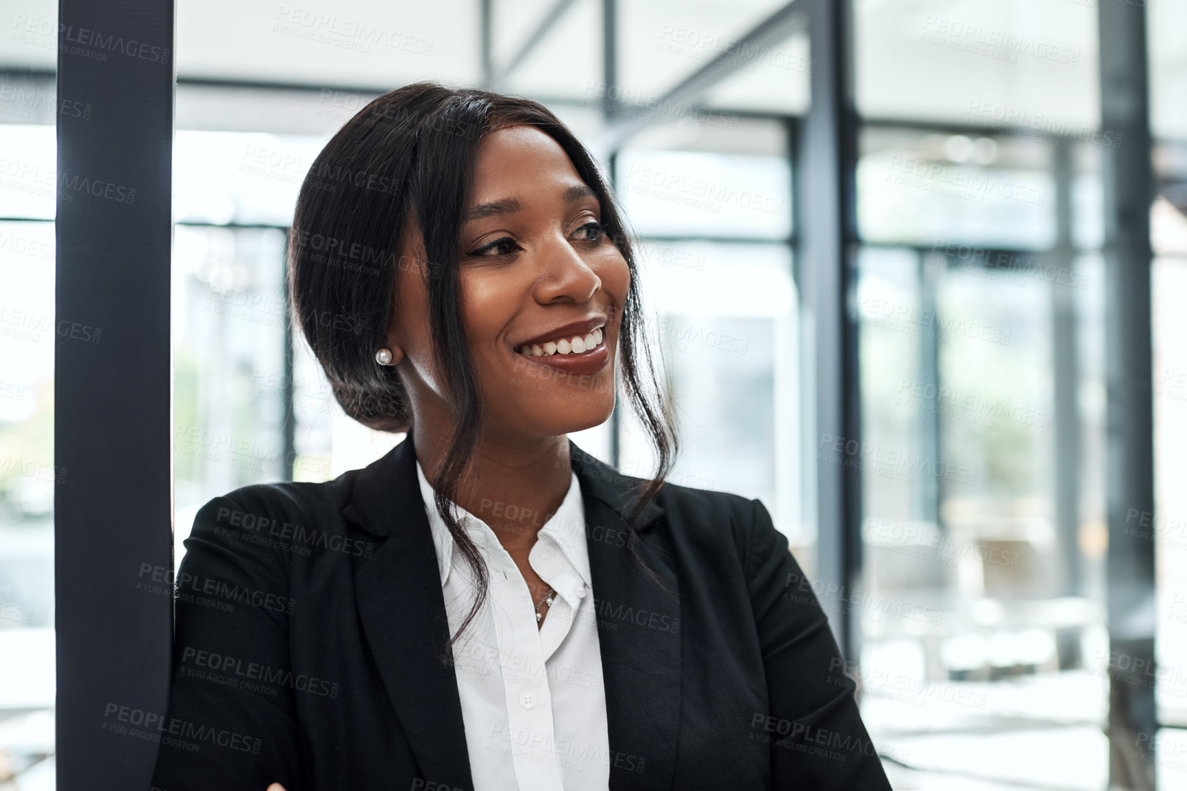 Buy stock photo Shot of a confident young businesswoman looking away thoughtfully in a modern office