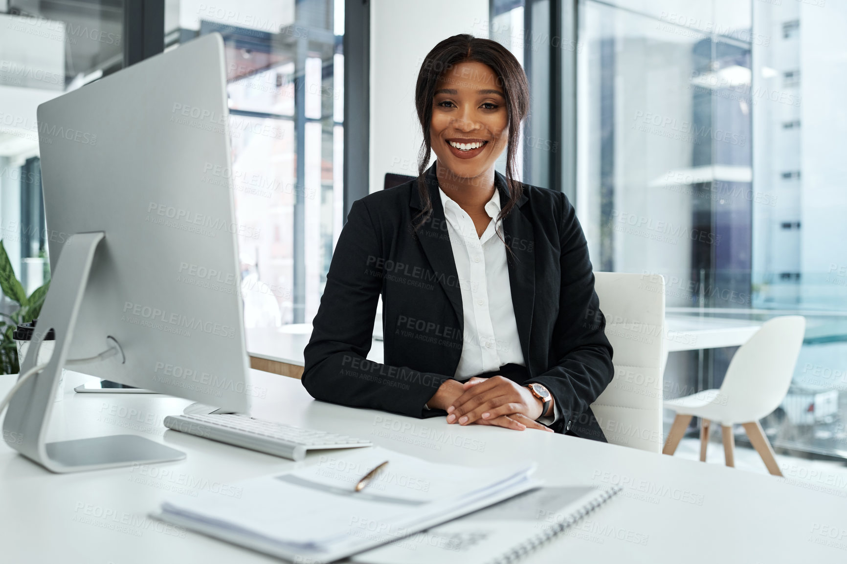 Buy stock photo Shot of a young businesswoman using a computer in a modern office