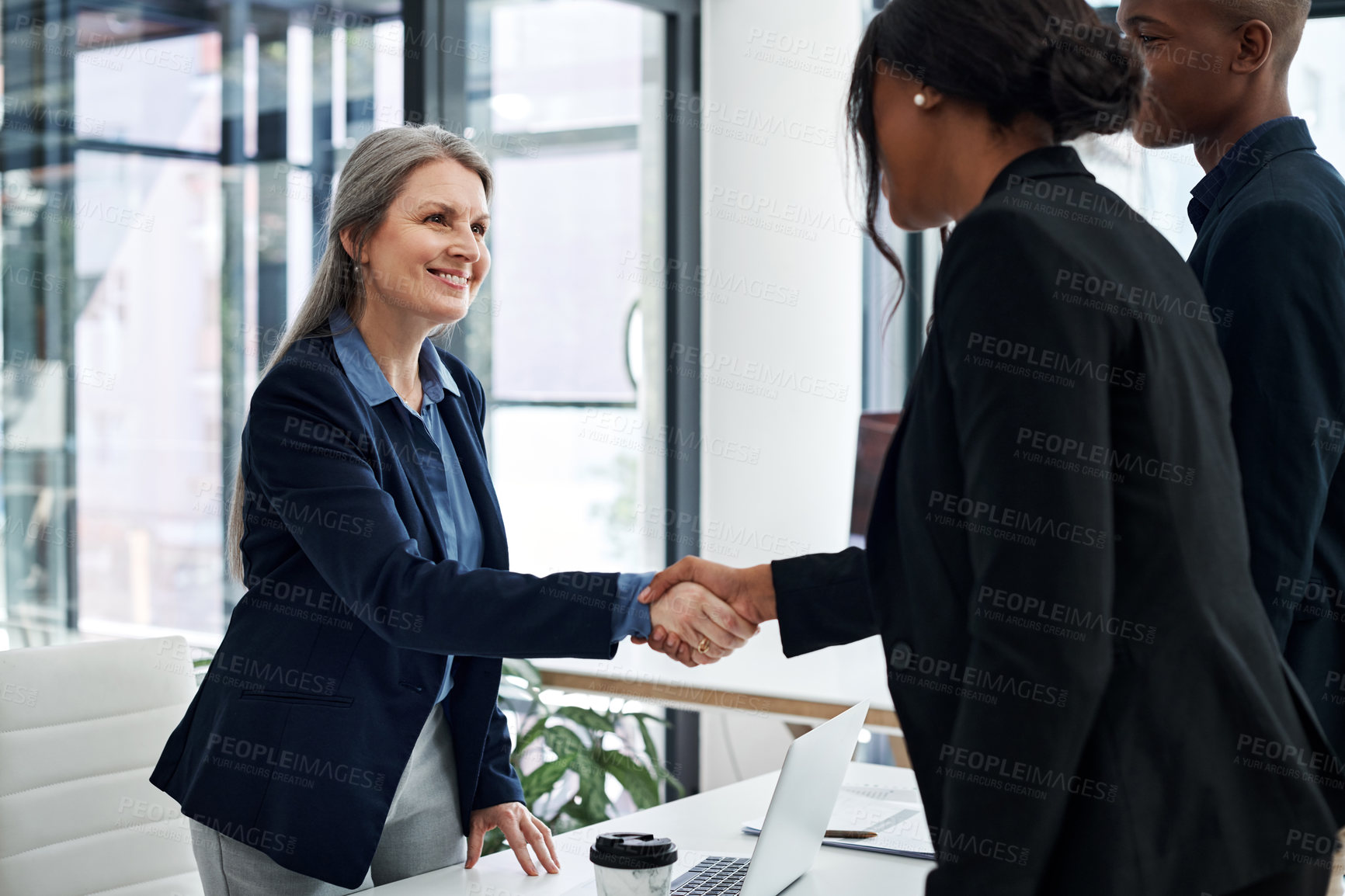 Buy stock photo Mature businesswoman, handshake and meeting in office with employee, greeting and onboarding in company. Female ceo, recruitment and hand gesture at desk for agreement, support and contract in hiring