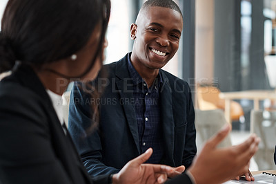 Buy stock photo Shot of a young businessman and businesswoman having a meeting in a modern office