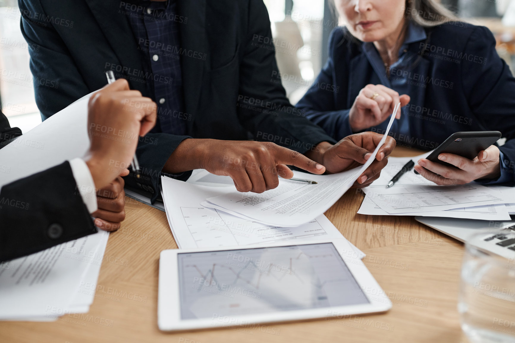 Buy stock photo Shot of a group of unrecognisable businesspeople having a meeting in a modern office