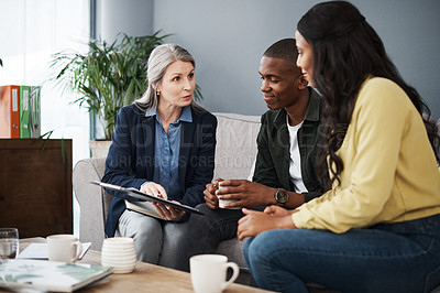 Buy stock photo Shot of a couple speaking to a financial advisor at home