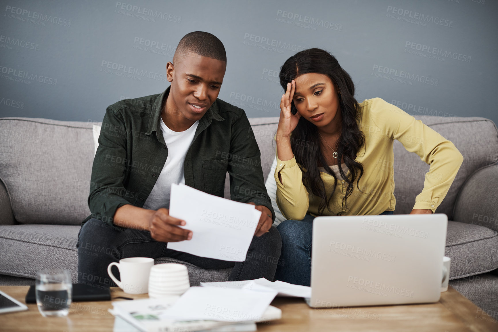 Buy stock photo Debt, finance and laptop with couple on sofa in living room of home for audit or tax review. Bankruptcy, computer or documents with man and woman in apartment for accounting, investment or money