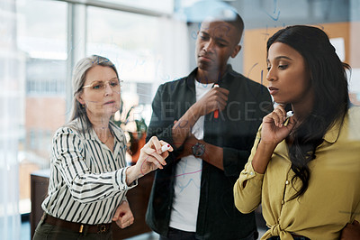 Buy stock photo Shot of a group of businesspeople brainstorming   in a modern office