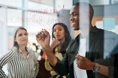 Buy stock photo Shot of a group of businesspeople brainstorming   in a modern office