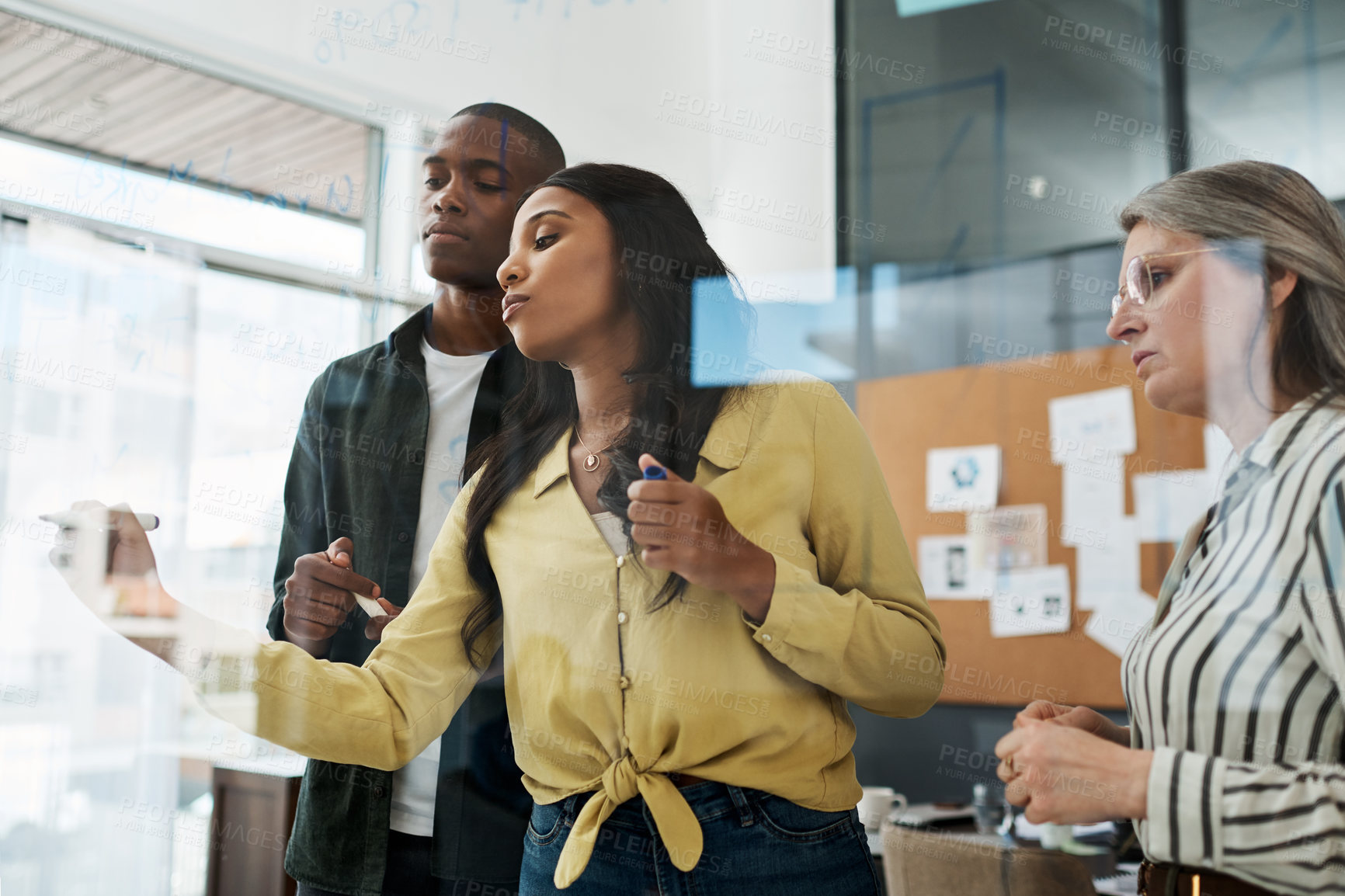 Buy stock photo Shot of a group of businesspeople brainstorming in a modern office