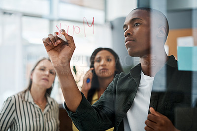 Buy stock photo Shot of a group of businesspeople brainstorming in a modern office