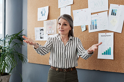 Buy stock photo Shot of a mature businesswoman doing a presentation in a modern office