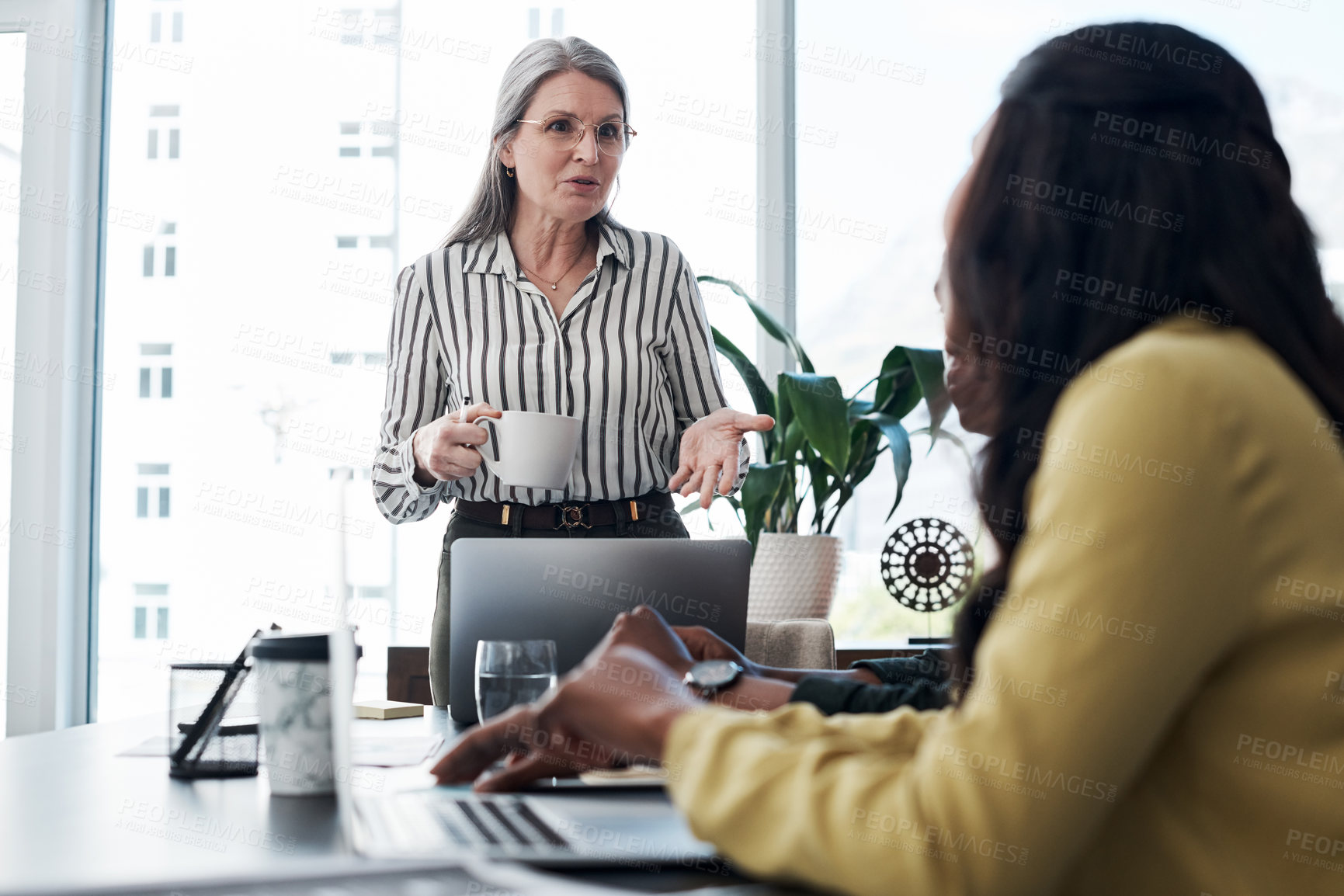 Buy stock photo Shot of a group of businesspeople having a discussion in a modern office