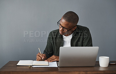 Buy stock photo Office, laptop and black man writing notes for research, schedule and online information in creative startup business. Computer, copywriter and notebook for planning, ideas and working on project