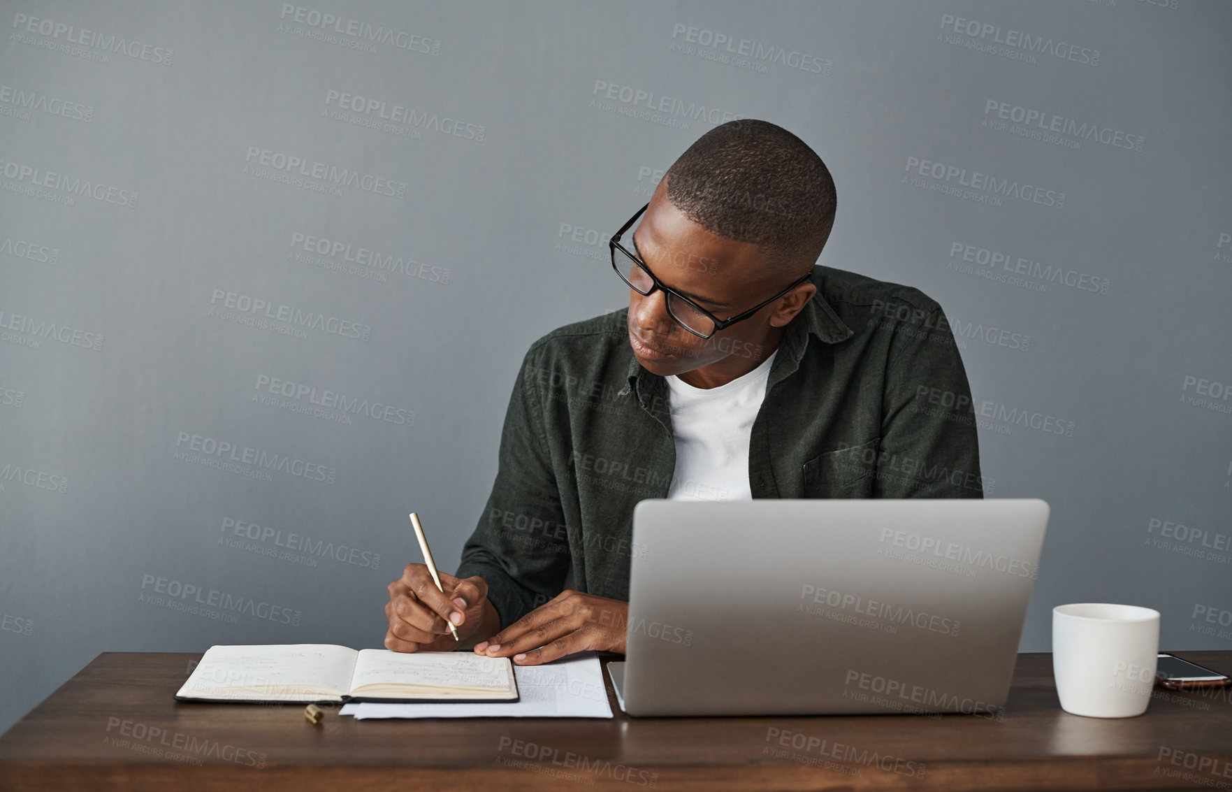 Buy stock photo Office, laptop and black man writing notes for research, schedule and online information in creative startup business. Computer, copywriter and notebook for planning, ideas and working on project