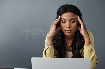 Buy stock photo Shot of a young businesswoman looking stressed while working from home