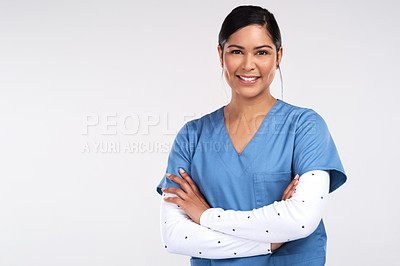 Buy stock photo Portrait of a beautiful young doctor standing with arms folded against a white background