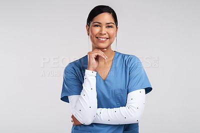 Buy stock photo Portrait of a young beautiful doctor in scrubs against a white background