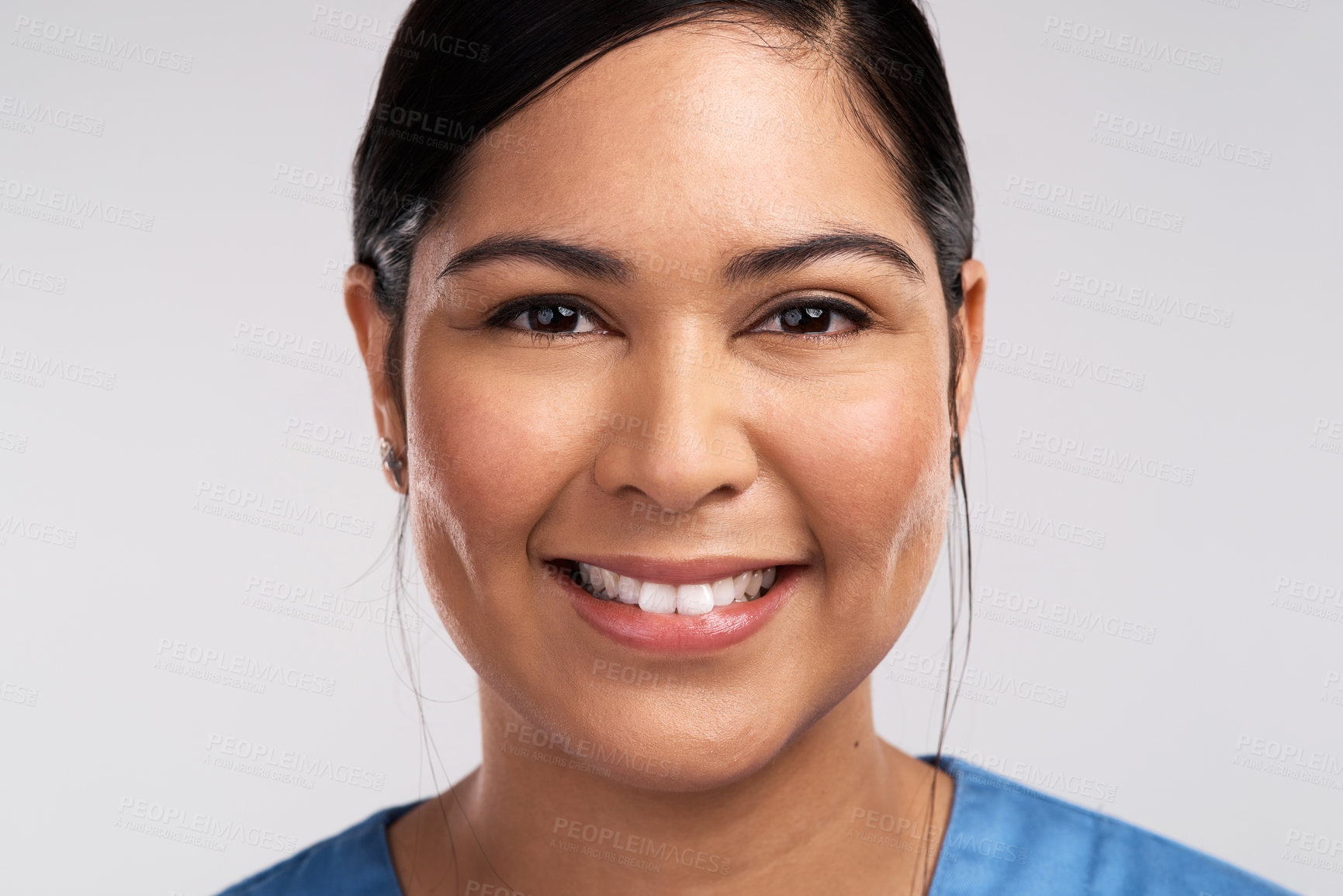 Buy stock photo Portrait of a young beautiful doctor in scrubs against a white background