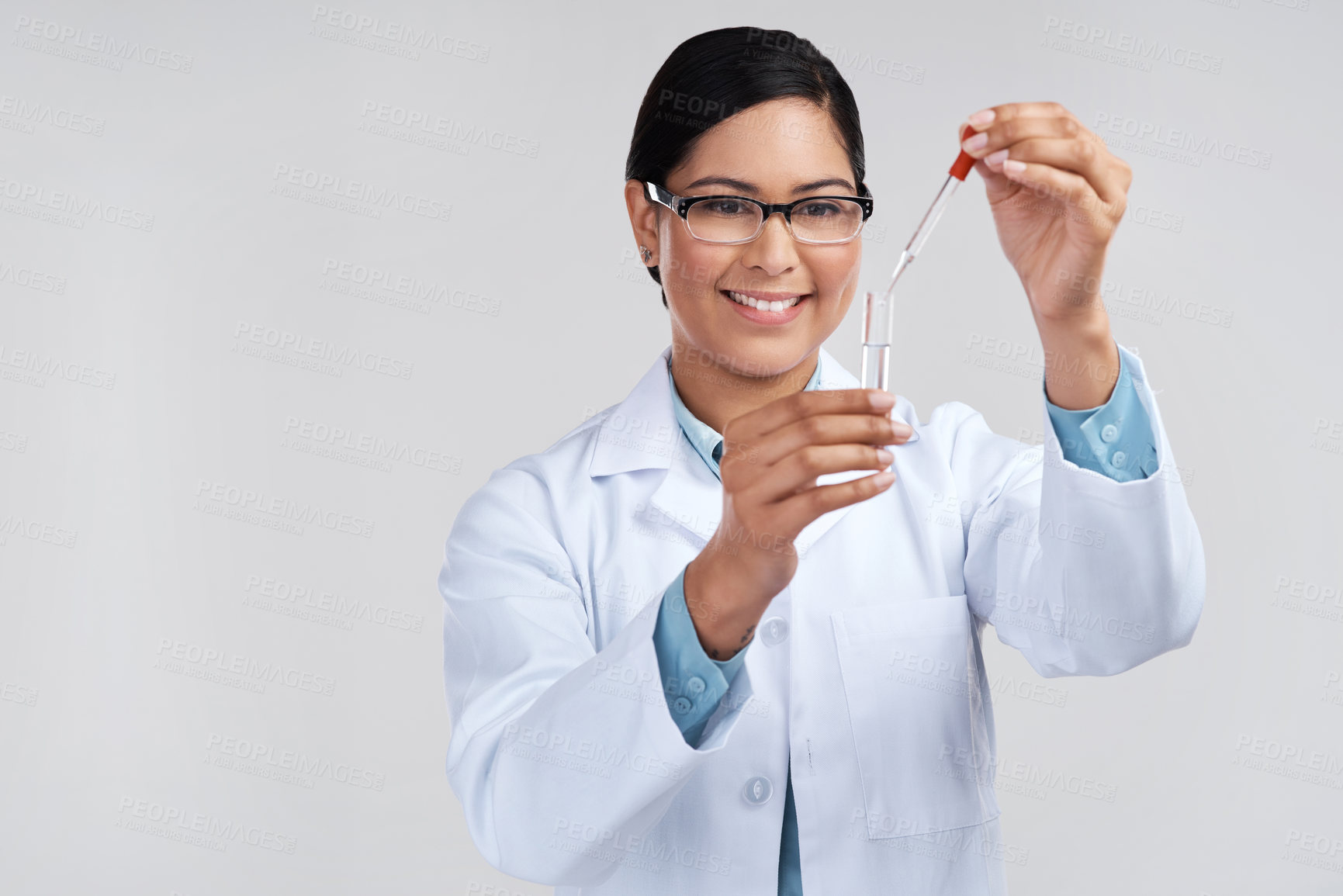 Buy stock photo Cropped shot of an attractive young female scientist mixing samples in studio against a grey background