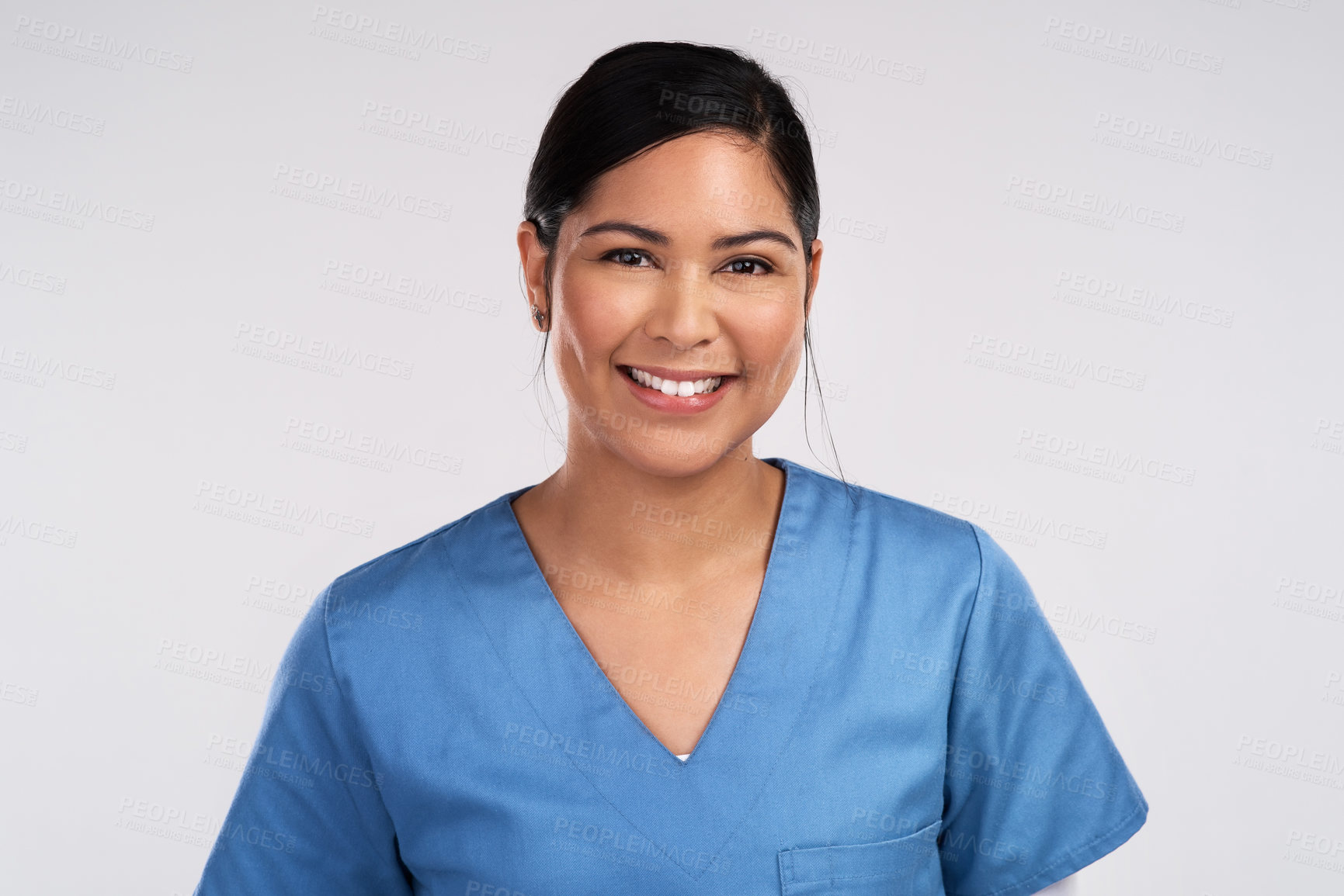 Buy stock photo Portrait of a young beautiful doctor in scrubs against a white background