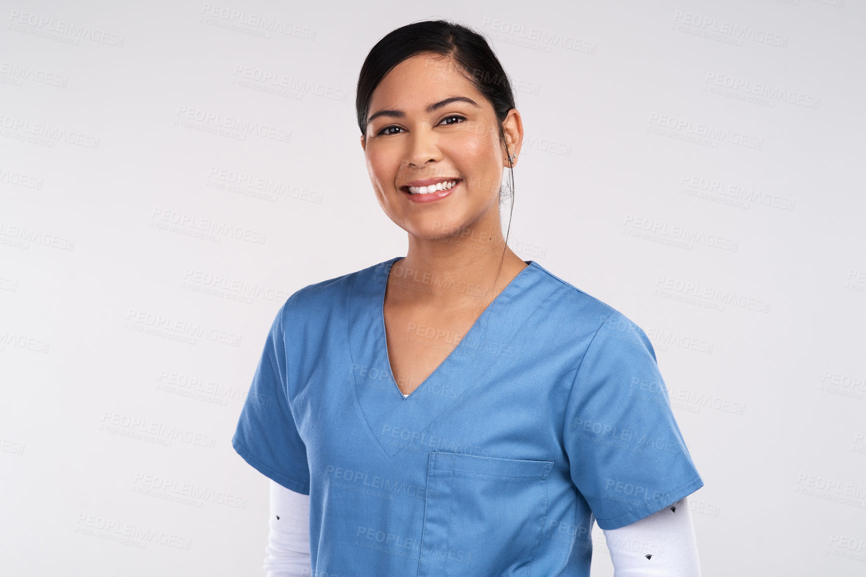 Buy stock photo Portrait of a young beautiful doctor in scrubs against a white background