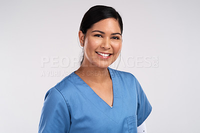 Buy stock photo Portrait of a young beautiful doctor in scrubs against a white background