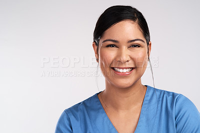 Buy stock photo Portrait of a young beautiful doctor in scrubs against a white background