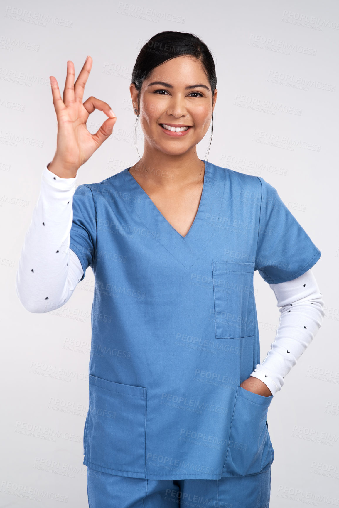 Buy stock photo Woman, nurse and happy in studio with ok hand gesture for healthcare, portrait or good service on white background. Person, medical professional and feedback with sign, symbol and smile in Colombia