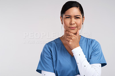 Buy stock photo Portrait of a young beautiful doctor deep in thought against a white background