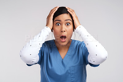 Buy stock photo Portrait of a mind blown young doctor in scrubs against a white background