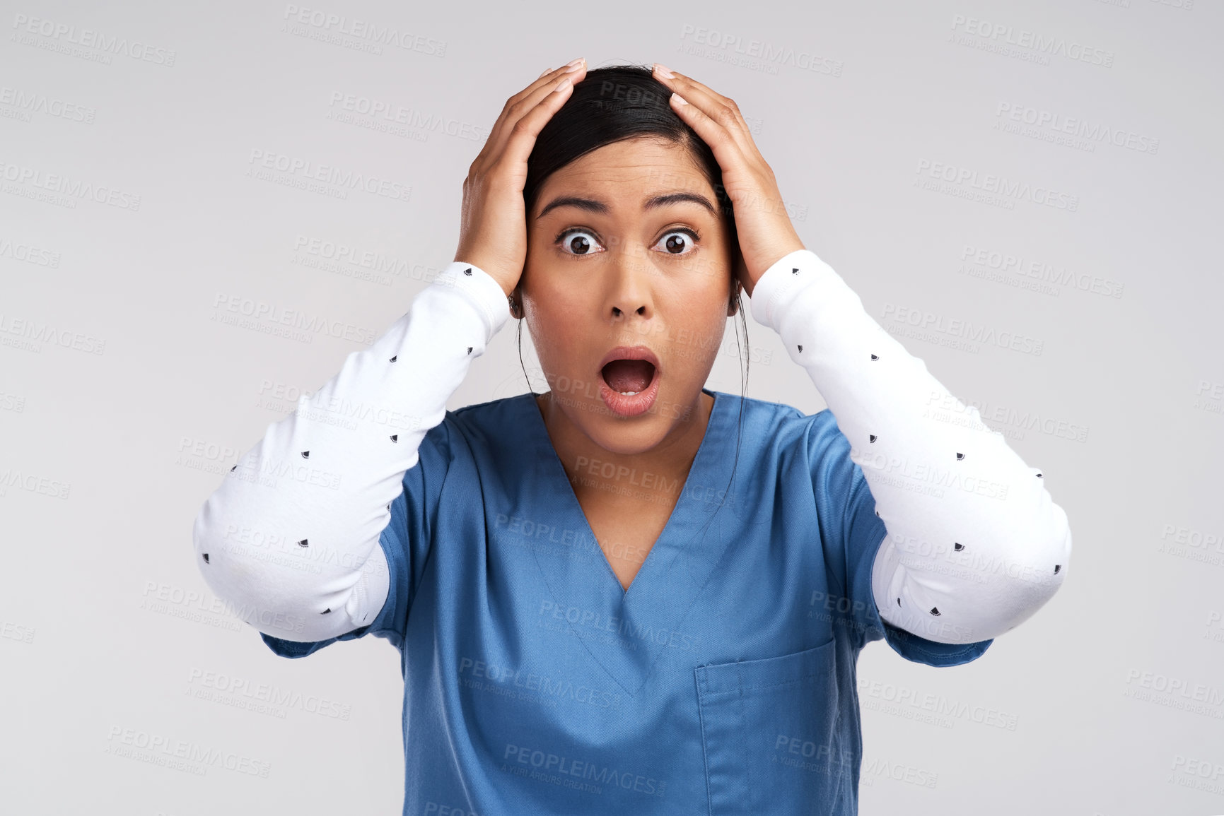 Buy stock photo Portrait of a mind blown young doctor in scrubs against a white background