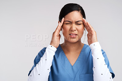 Buy stock photo Shot of young doctor fighting a headache against a white background