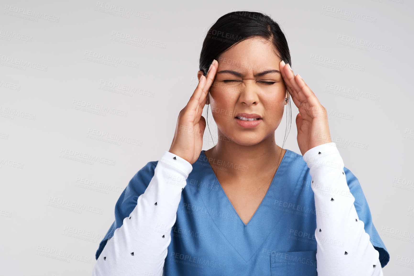 Buy stock photo Shot of young doctor fighting a headache against a white background