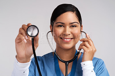 Buy stock photo Portrait of a young doctor using a stethoscope against a white background