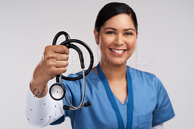 Buy stock photo Portrait of a young doctor  holding a stethoscope against a white background
