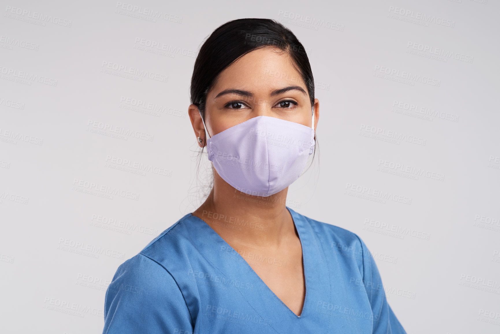 Buy stock photo Portrait of a young doctor  wearing a face mask against a white background