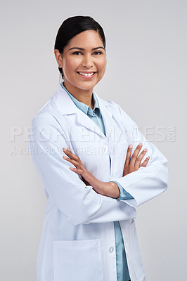 Buy stock photo Cropped portrait of an attractive young female scientist standing with her arms folded in studio against a grey background