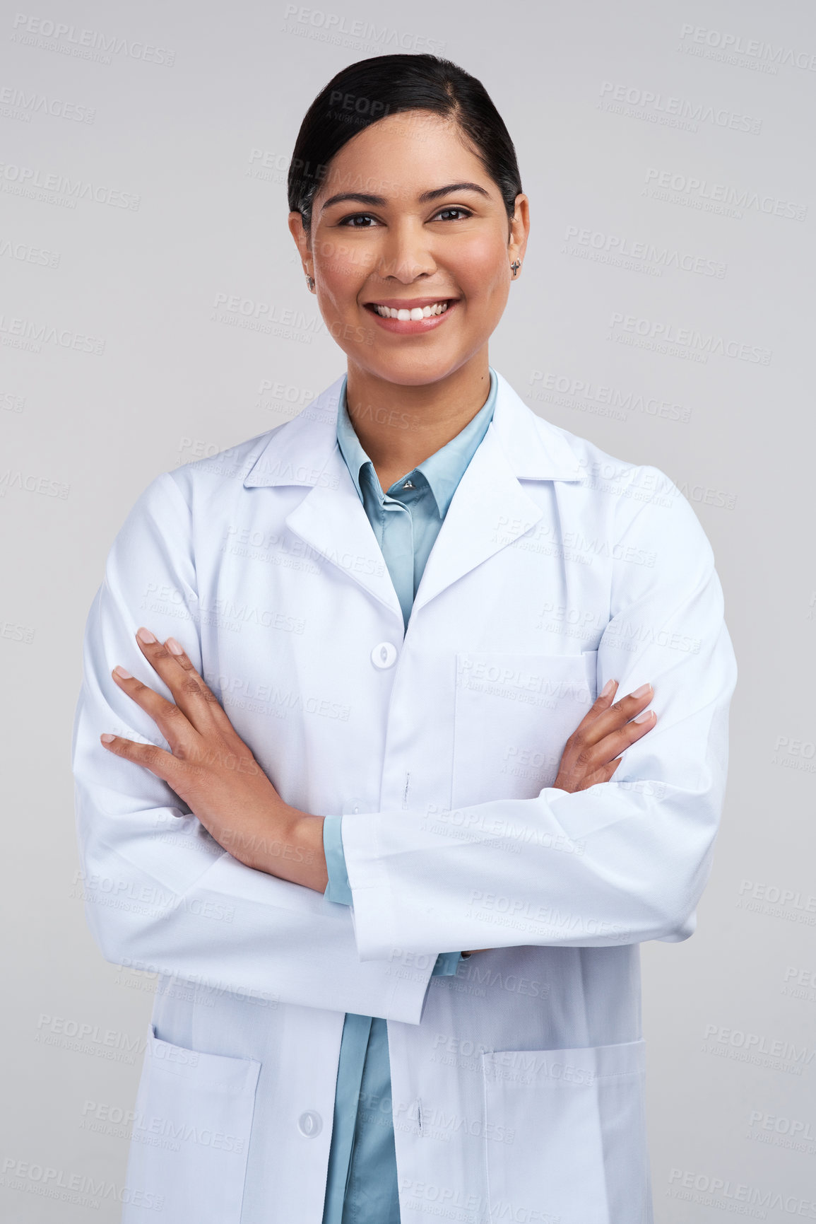 Buy stock photo Cropped portrait of an attractive young female scientist standing with her arms folded in studio against a grey background