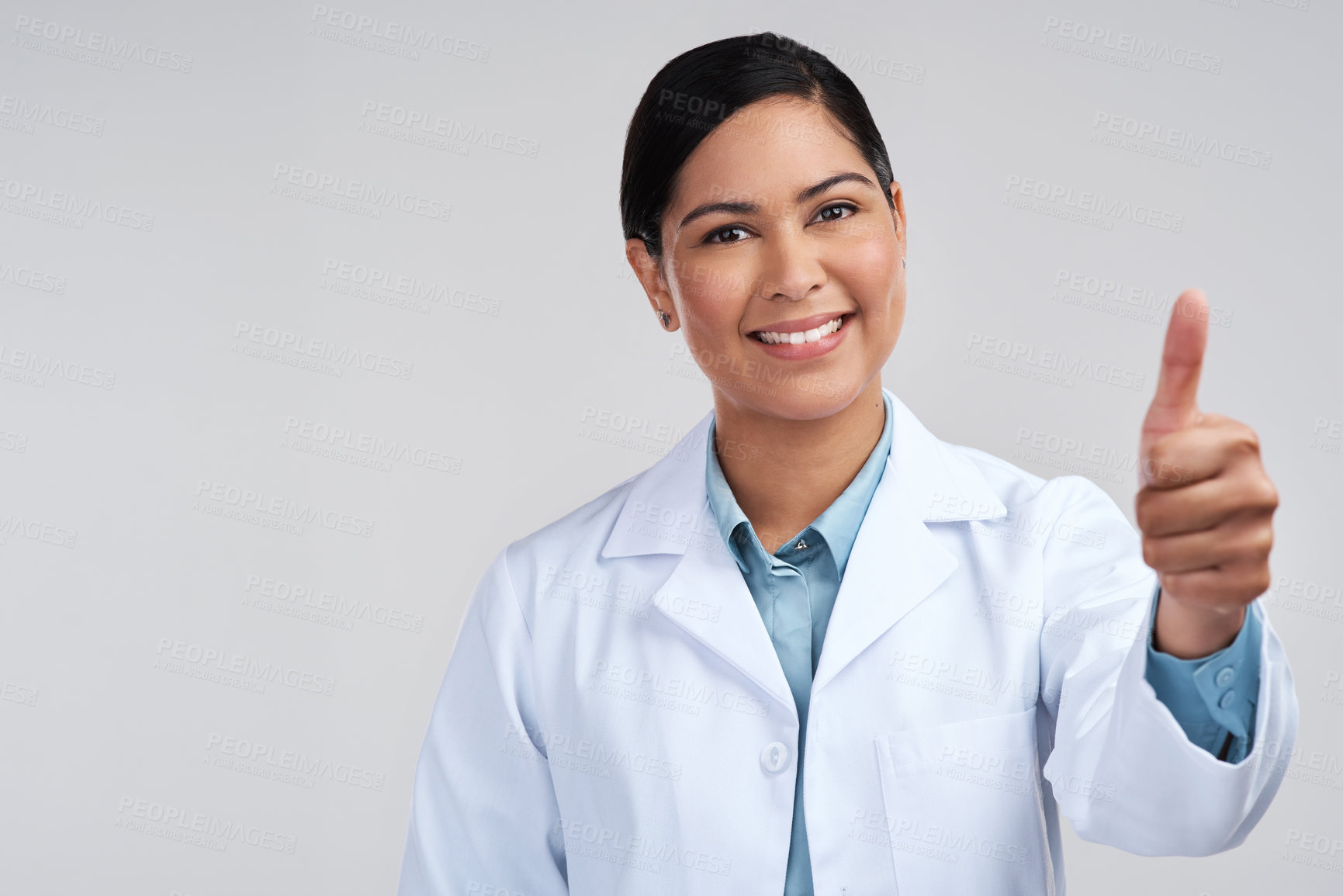 Buy stock photo Cropped portrait of an attractive young female scientist gesturing thumbs up in studio against a grey background