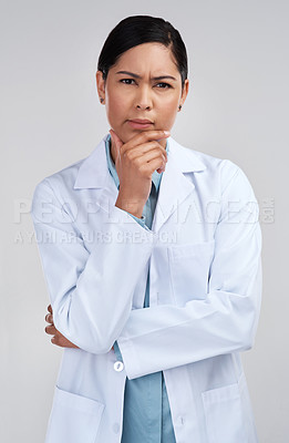 Buy stock photo Cropped portrait of an attractive young female scientist looking thoughtful in studio against a grey background
