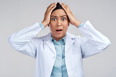 Buy stock photo Cropped portrait of an attractive young female scientist looking shocked in studio against a grey background