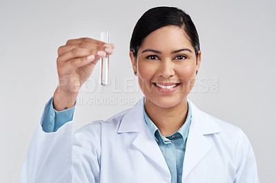 Buy stock photo Cropped portrait of an attractive young female scientist holding a vial filled with liquid in studio against a grey background