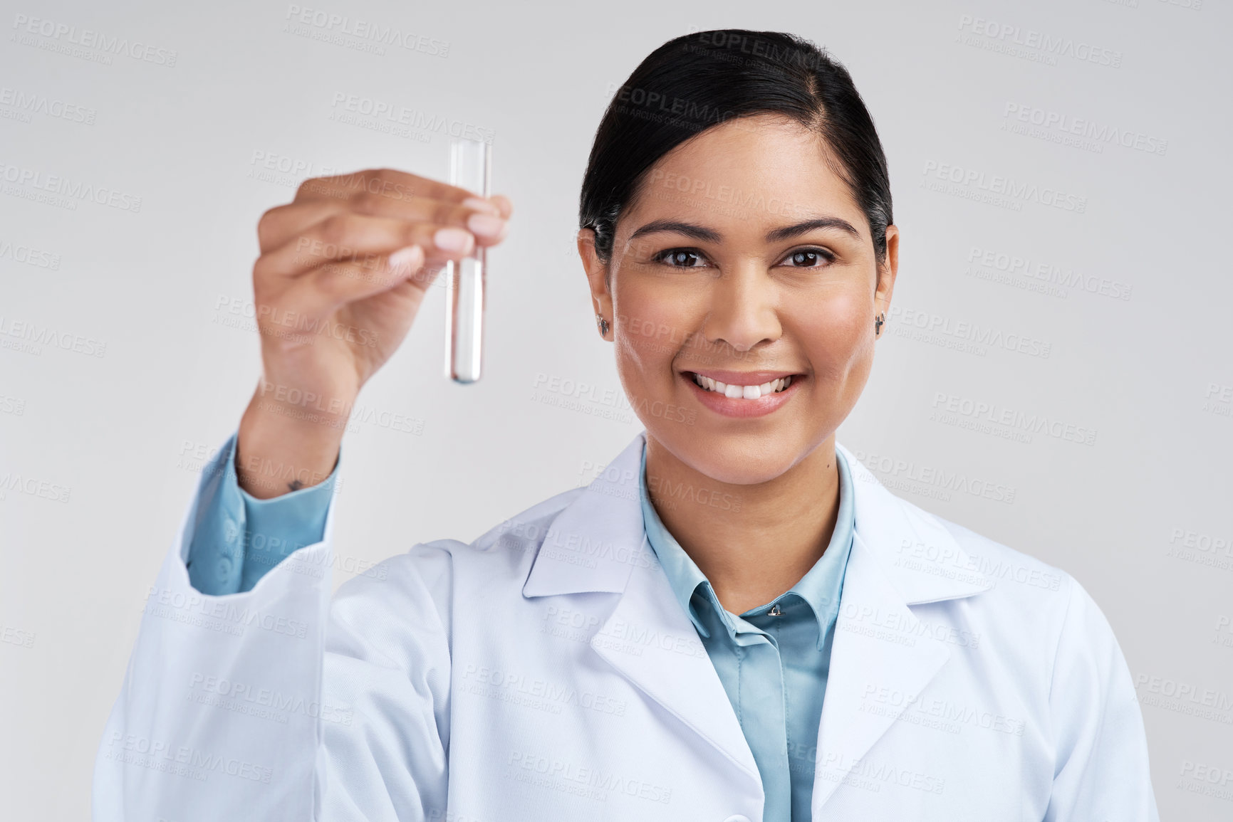 Buy stock photo Cropped portrait of an attractive young female scientist holding a vial filled with liquid in studio against a grey background