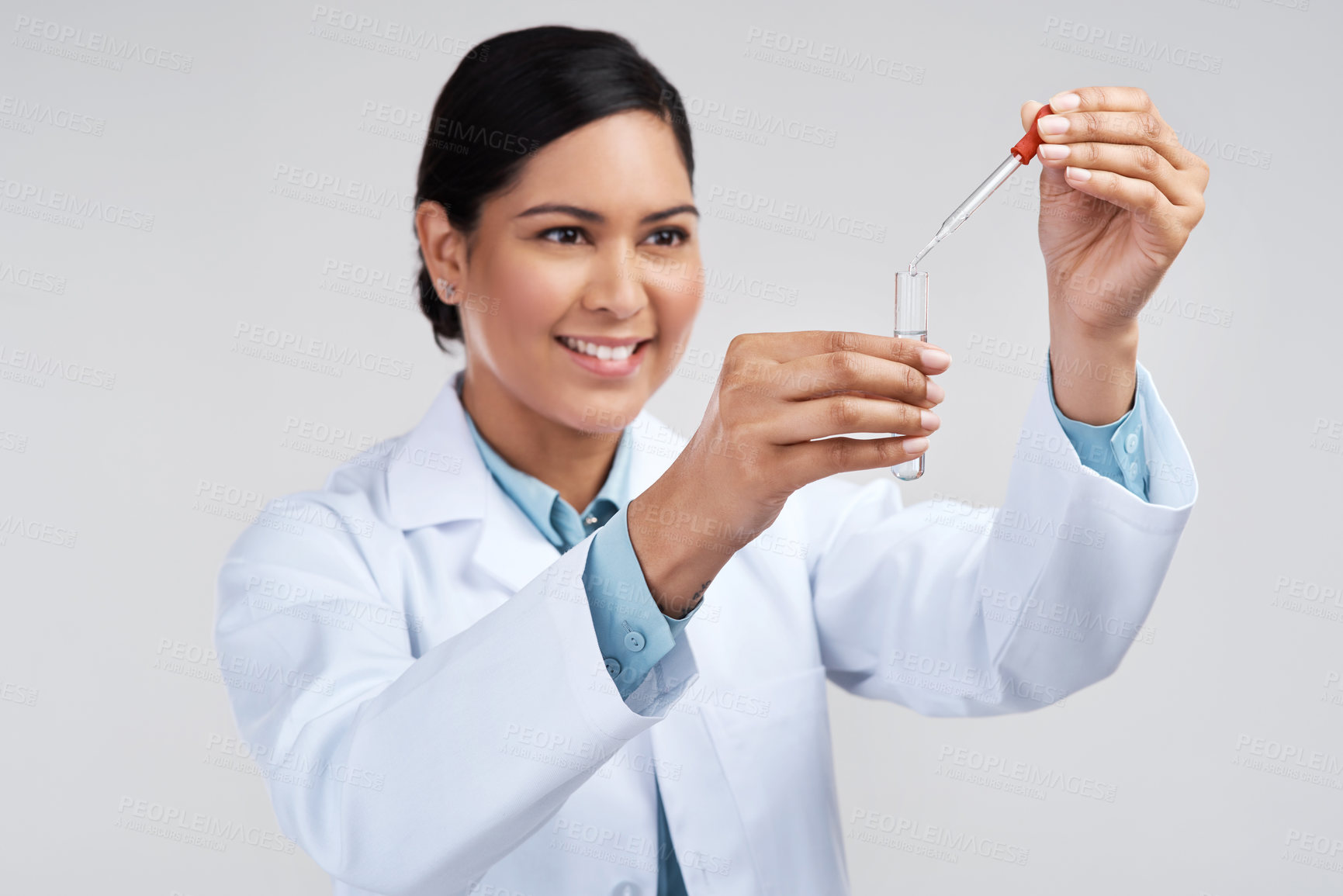 Buy stock photo Cropped shot of an attractive young female scientist mixing samples in studio against a grey background